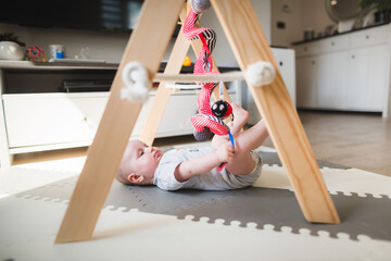 baby playing with a baby gym