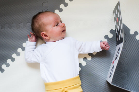 Baby Looking At Black And White Contrast Book