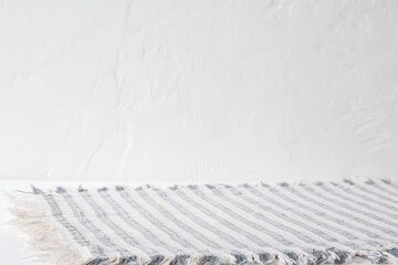 Blue and white striped fabric placemat with empty space for product placement or text. White table...