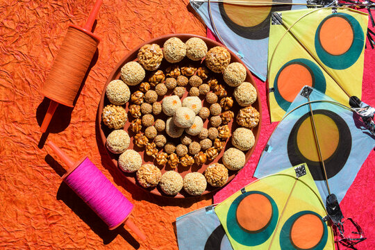 Many types of ladoo like Amaranth ladoo or Rajgira, Puffed rice or mamra, Peanut laddu, til sesame laddo, tilgur mawa white sweet balls. Sankrant or Uttarayan special sweets food. Uttarayan kites