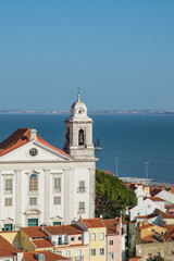 Historical cathedral from alfama and Tejo River with a smal sailboat seen from Saint Jorge Castle in Lisbon