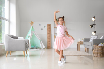 Fototapeta Adorable little ballerina dancing at home obraz