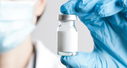 Scientist or medical worker holds vaccine bottle.Vaccination, immunization, treatment to provides active acquired immunity to a particular infectious disease. Healthcare And Medical concept.