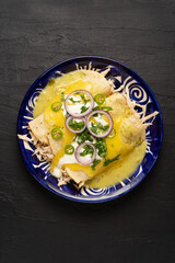 Mexican green enchiladas with chicken and melted cheese