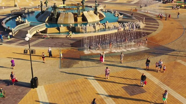 Сhildren run through fountains