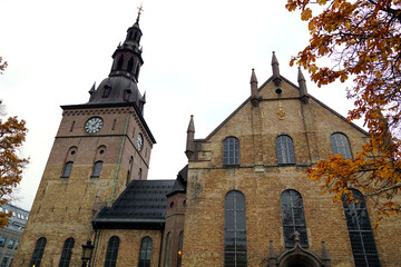 Church with a yellow brick facade with arcades and architectural decorations