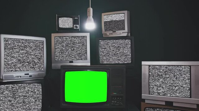 Stacked Retro TVs turning On Green Screens. Sepia Tone.