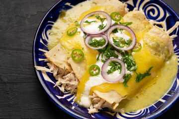 Mexican green enchiladas with chicken and melted cheese