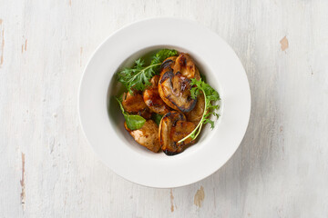 Food. Grilled mushrooms with basil on a plate. Top view. Free space for your text
