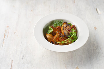 Food. Grilled mushrooms with basil on a plate. Top view. Free space for your text