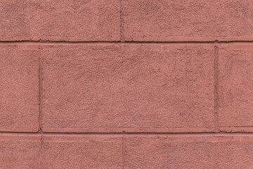Fototapeta premium Part of the facade of the house with painted wall of brick blocks with brown paint exterior architecture background