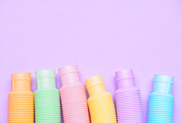 Different colorful Pop Tubes on purple background