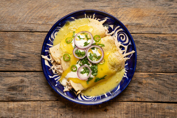 Mexican green enchiladas with chicken and melted cheese