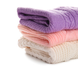 Stylish baby sweaters on white background