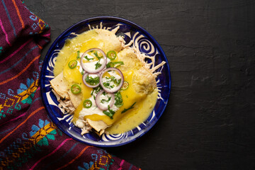 Mexican green enchiladas with chicken and melted cheese