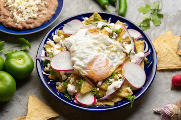Mexican green chilaquiles with fried egg and cheese