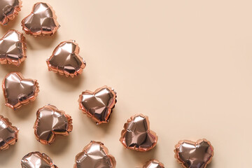 Heart-shaped air balloons for Valentine's day on beige background