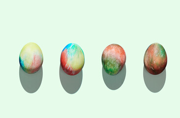 Pattern of easter eggs on green pastel background