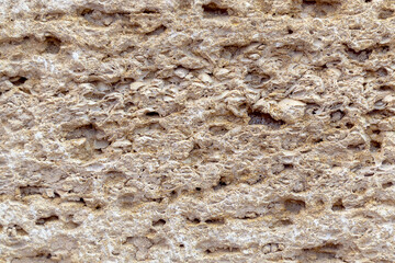 A section of sandstone photographed in close-up. Building material. The building block is made of sandstone.