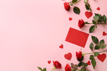 Composition with blank card, paper hearts and rose flowers on color background. Valentine's Day...