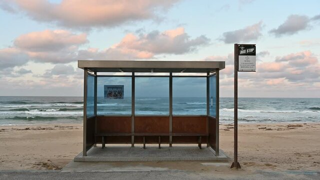 Bus stop on seaside beach with colorful sky at Jumunjin beach