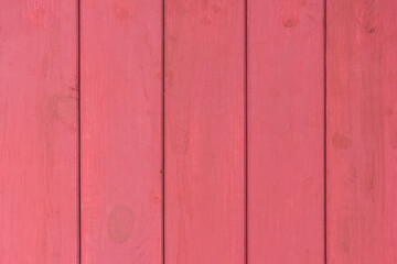 Vertical wooden boards painted in red paint surface texture background