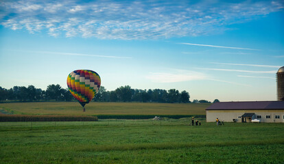 Hot Air Balloons Landing in Farmlands as Amish Look on, and More Still in Flight