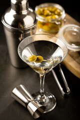 Dry martini drink with green olives.