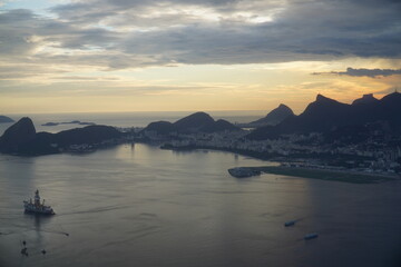 Rio de Janeiro shortly before sunset. View from the airplane after takeoff at the Central Airport. Guanabara Bay with the Sugar Loaf in the Urca district and the Christ Statue on the other side.