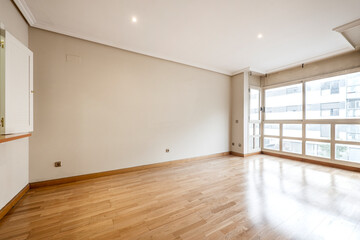 Fototapeta na wymiar living room with large window, service window to the kitchen and oak parquet floors