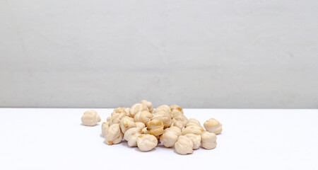 chickpeas in a pile, in front of a white background