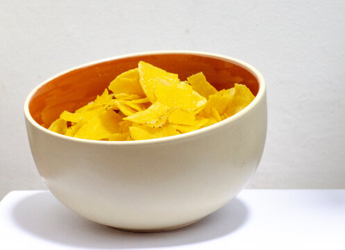 bowl of chifles (fried plantain) on a white background