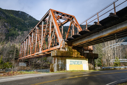 Index, WA, USA - February 08, 2021; Town entrance sign at index under BNSF railroad bridge