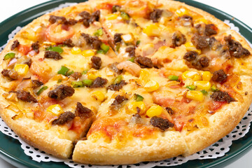 angle view fresh pizza with beef and bacon toppings close up