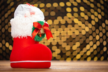 Christmas boot with gifts on a wood table