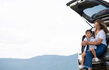 Asian family.happy little girl with family sitting in the car.Car insurance concept