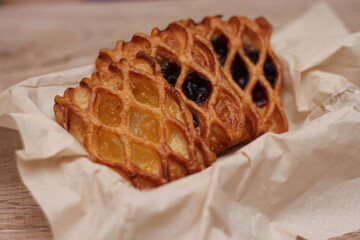 Lattice Jam Tart served in a plate on a wooden table.