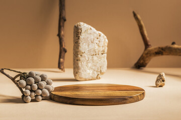 Rustic cylinder board on bright brown background with stones and branches objects. Mock up for branding products, presentation and health care.	
