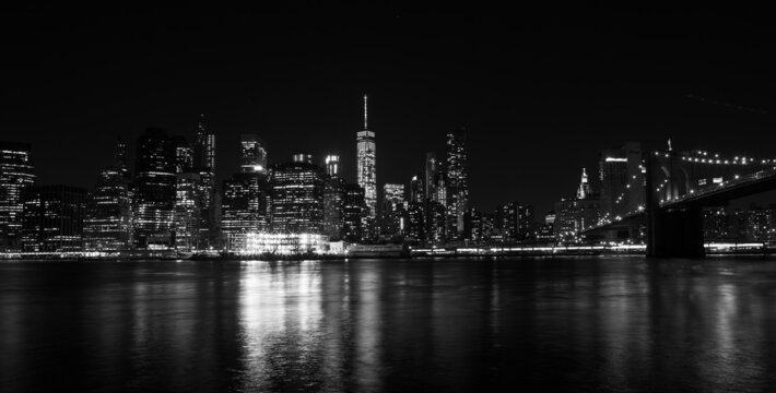 Partial night view of Manhattan from Brooklyn photographed in black and white