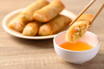 Asian deep fried spring roll filling with tofu, cabbage, carrot and glass noodle on natural plate...