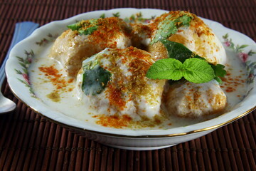 homemade traditional indian gujarati snack food dahi vada or thayir vadai in bowl, top view 