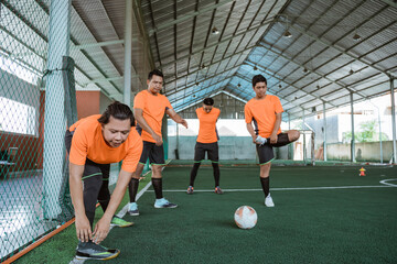 futsal players stretch with the team before the futsal match