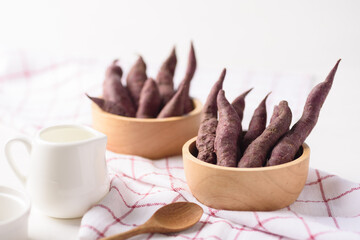 Small purple sweet potatoes from local organic agriculture for sustainability on white background