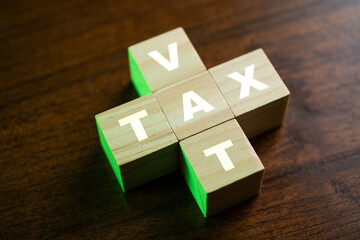 TAX VAT on wood block. Business concept.