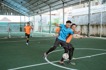 players in blue uniforms fight over the ball with opposing