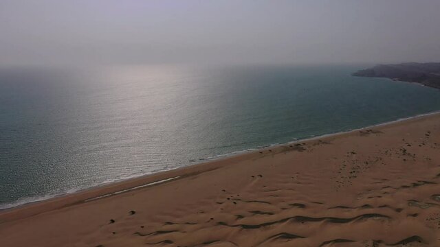 Aerial View Of Arabian Sea With Tilt Down View Of Desert Sand Dunes Beside It In Balochistan  