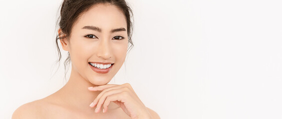 Obraz na płótnie Canvas Closeup portrait of beauty asian woman with fair perfect healthy glow skin hand touching chin isolated on white, young beautiful asia girl with pretty smile on face. Beauty korean spa skincare banner