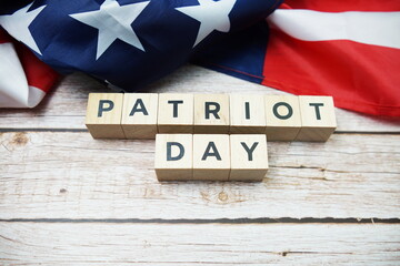 Patriot Day alphabet letter and American flag on wooden background