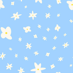 Seamless pattern with flowers. Abstract cute pattern with white flowers on a blue background. Random, chaotic pastel background with daisies.