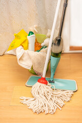 Domestic cleaning, worth with some cleaning products and two different types of mops for wood and tile or laminated floors.